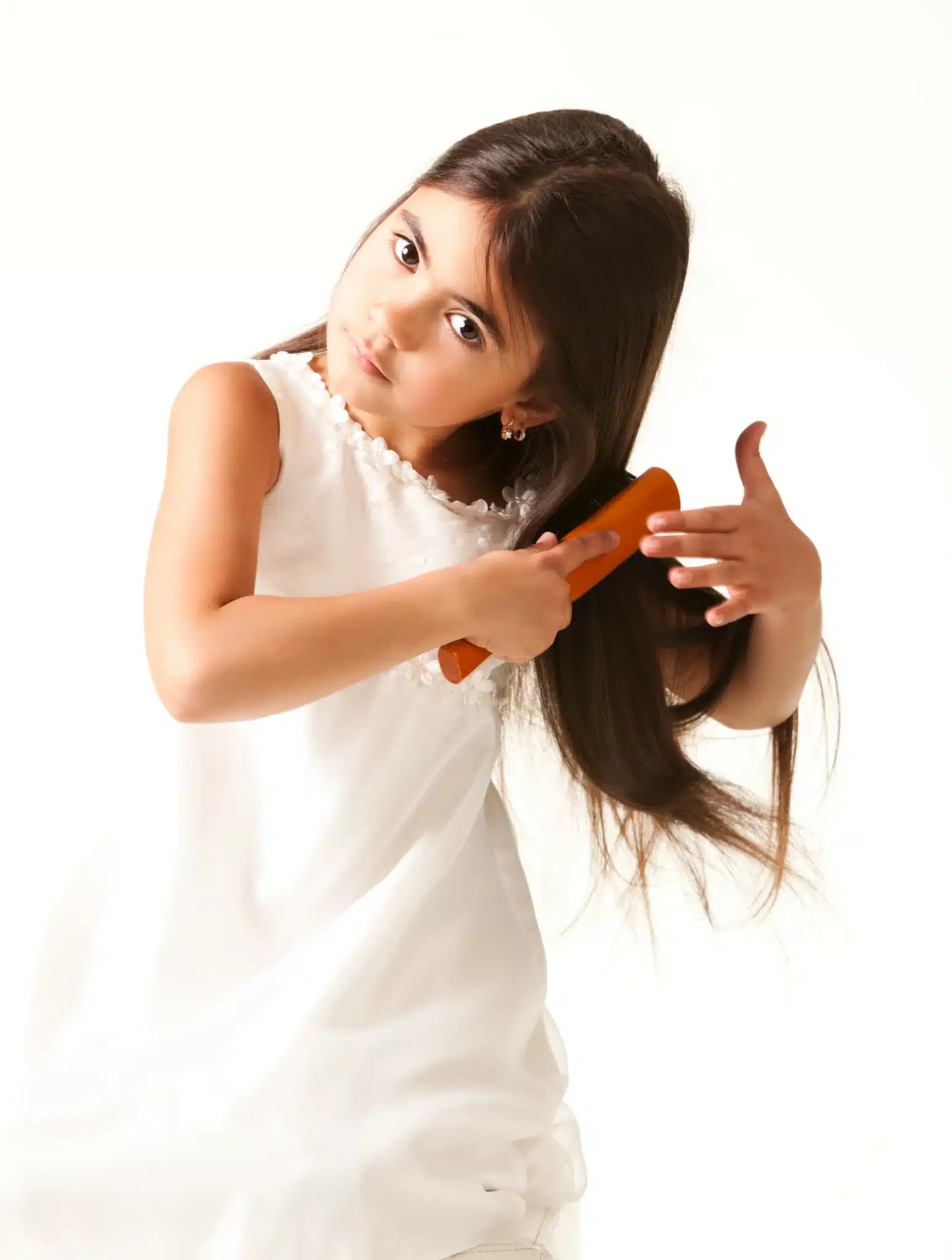 Warminster girl in white dress combing brown hair scaled