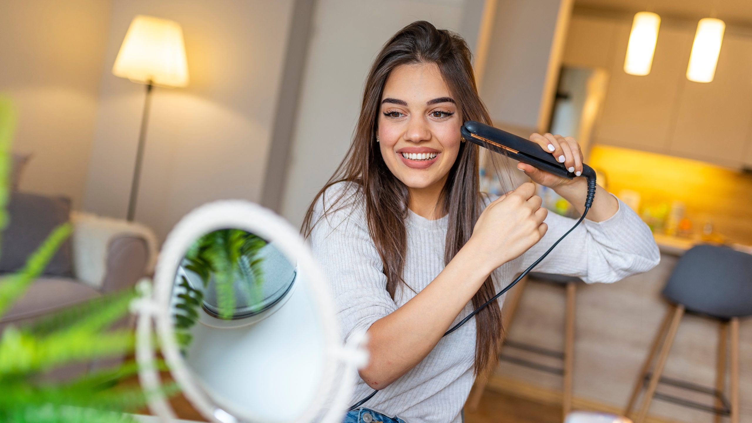 Parent considering a ceramic hair straightener at home after a school lice notice