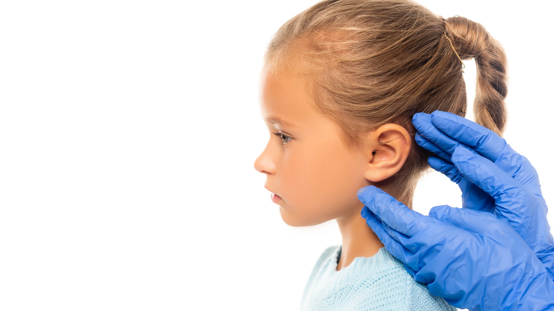 Blue-gloved hands checking the hair behind a person's ear.