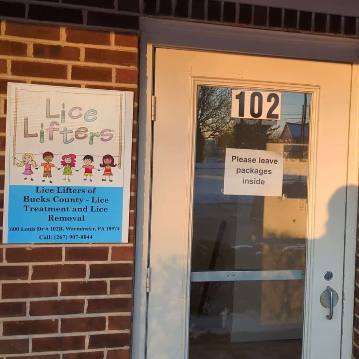 Treatment image by Lice Lifters Of Bucks County - Lice Treatment and Lice Removal Entrance door numbered 102 beside a Lice Lifters sign on a brick wall.